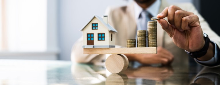 gangorra mostrando imóvel e dinheiro para matéria de fundo imobiliário de home equity